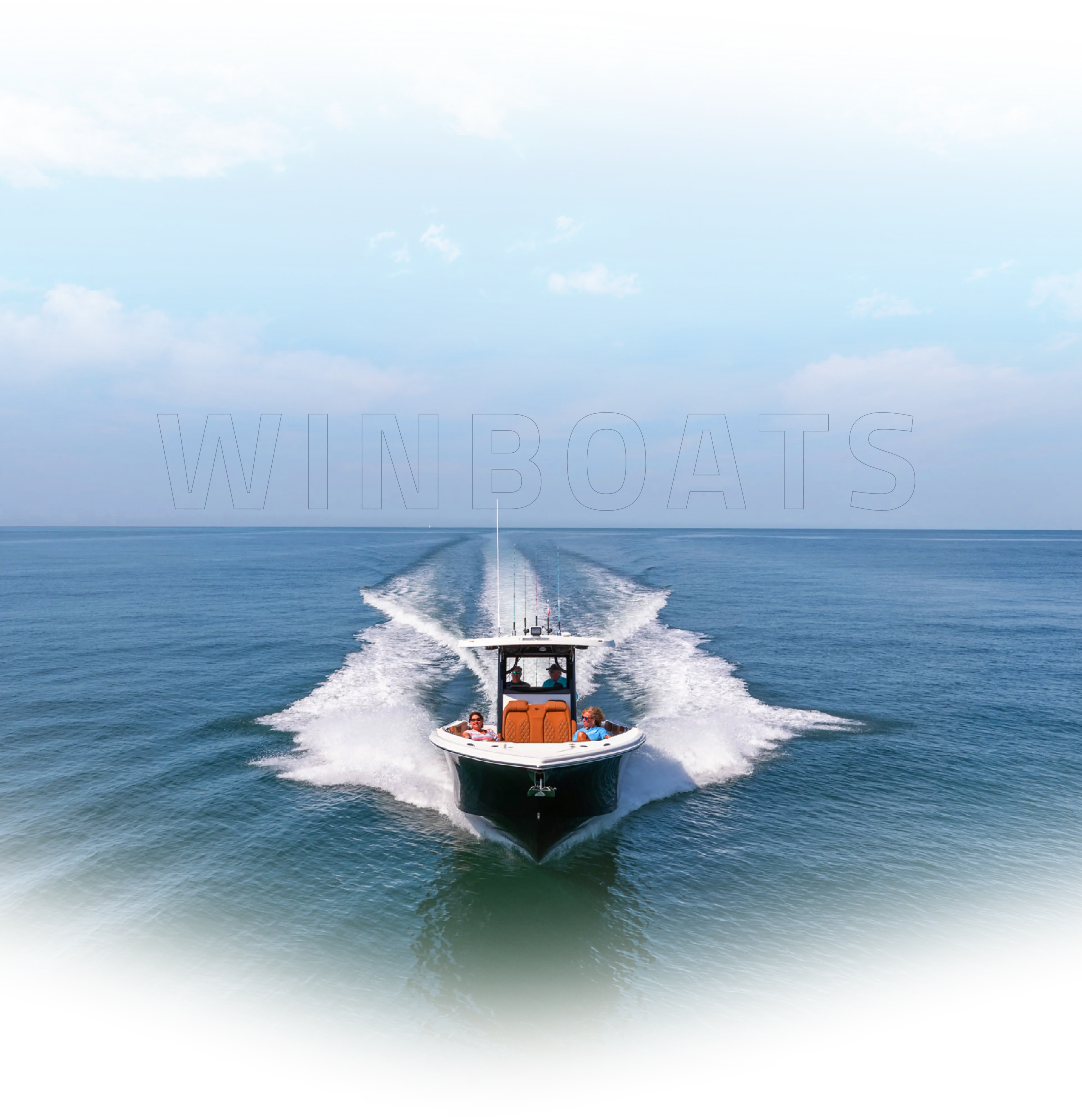 Center console boat speeding across open ocean under clear blue sky, leaving a white wake behind.
