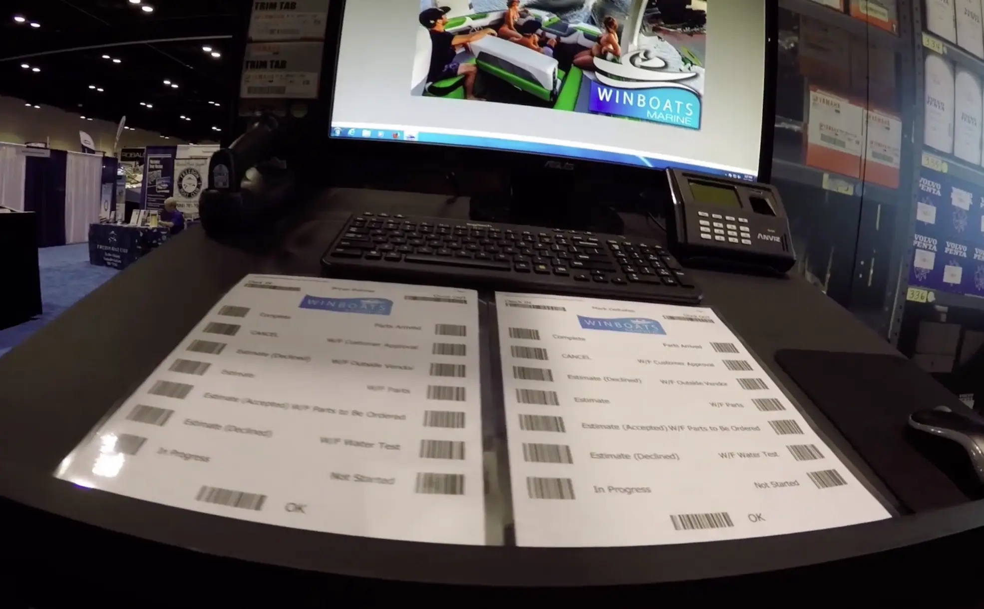 Computer workstation with winboats marine documents and barcode templates displayed for dealership task management.