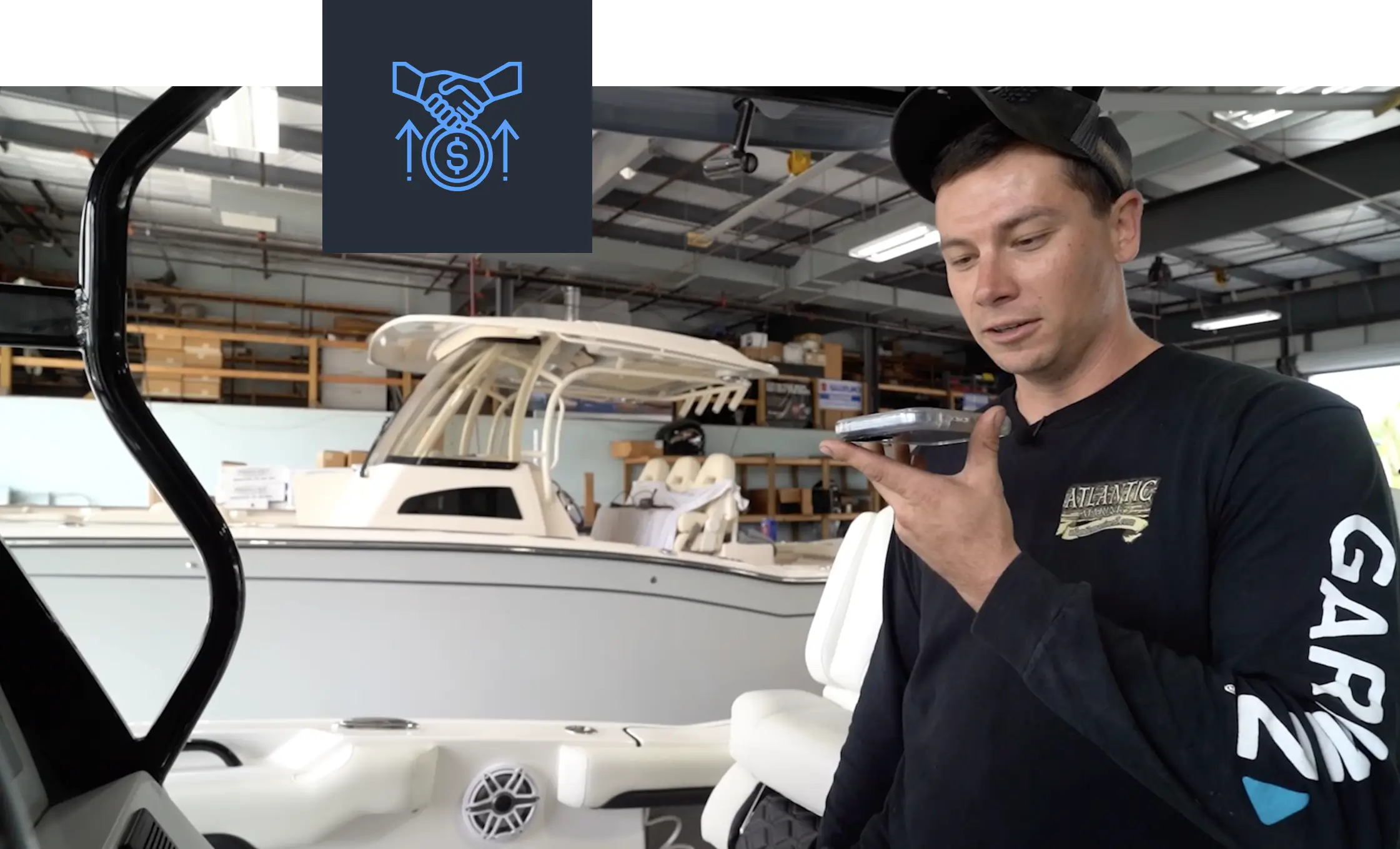 Winboats salesperson using a mobile phone on a boat lot, receiving automated reminders for customer follow-ups.