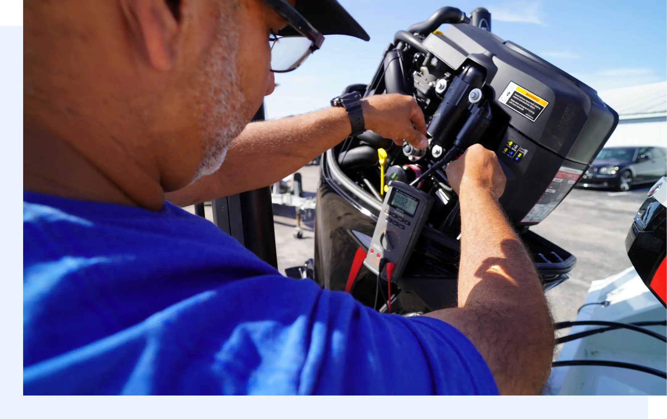 Marine service workshop with organized tools and technician performing boat engine diagnostics, showcasing winboats workflow management and productivity optimization.